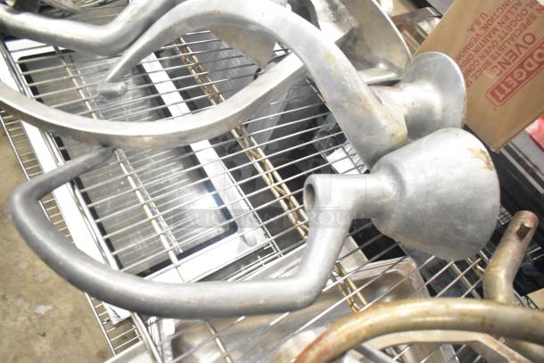 15 various attachments for Hobart mixer, including dough hooks, paddle whips, and whisk. Metal construction, moderate use condition.