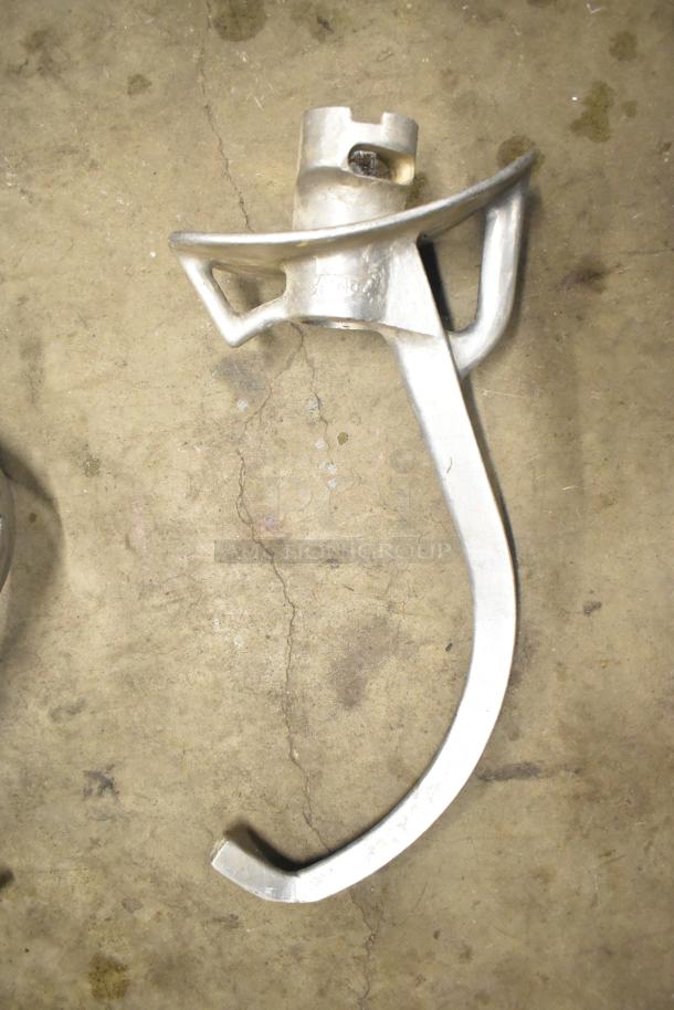 15 attachments for Hobart Mixer, including dough hooks, paddle whips, and whisk. Slight wear, enhances mixer versatility.