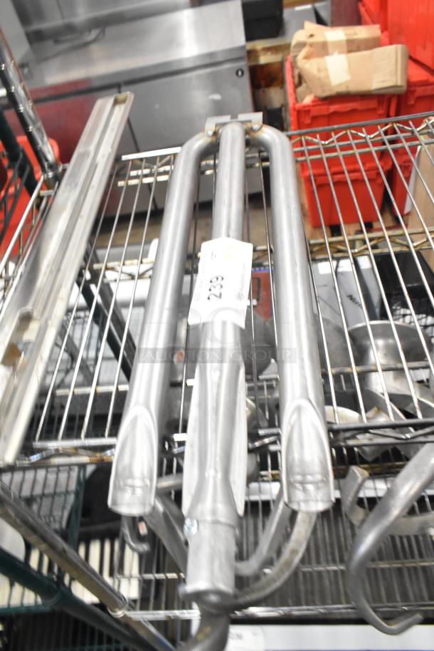 Metal burner and another unidentified item on a wire rack. Visible label indicating auction lot number 239.