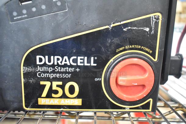 Duracell Jump Starter and Compressor, 750 Peak Amps, black casing with red power dial, visible wear on surface.