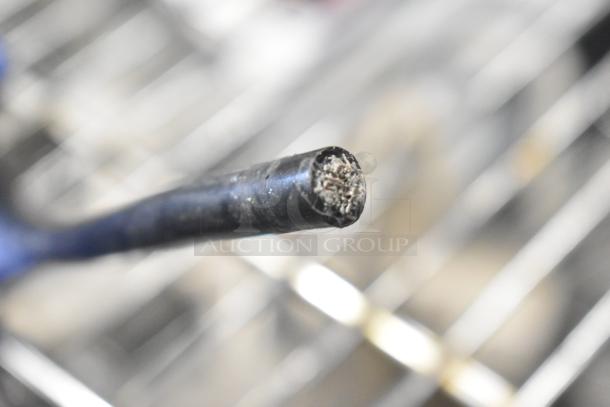 Close-up of a damaged cable from a Duracell Jump Starter and Compressor, showing exposed wire strands.