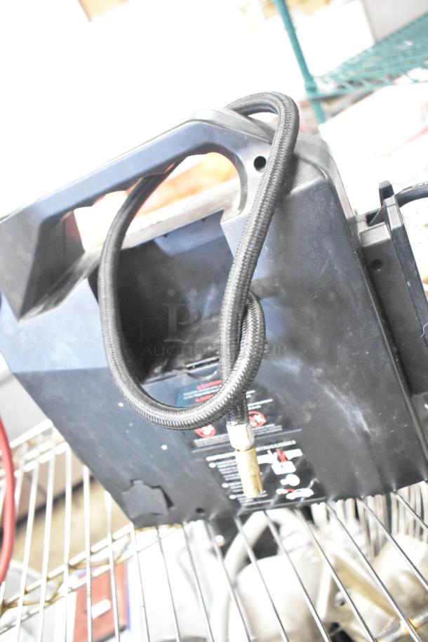 Duracell Jump Starter and Compressor, showing power cable and connector. Used condition, some wear visible on casing.