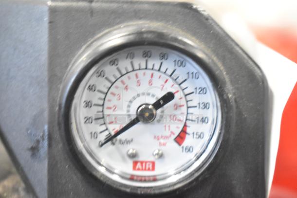 Duracell Jump Starter and Compressor gauge showing air pressure in psi and bar.