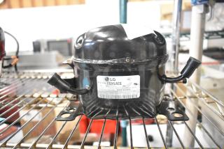 LG TS24LACG Compressor, 115V, 1 Phase. Model R134a with wiring connectors, black finish, UL marked, in good condition.