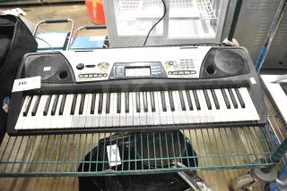 Yamaha PSR-175 keyboard with 61 keys, built-in speakers, various control buttons, and LCD screen. Used condition.
