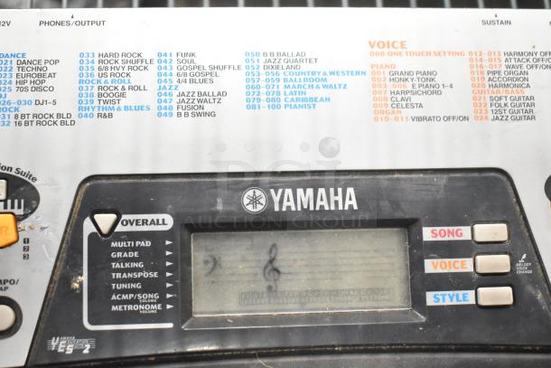 Yamaha PSR-175 Keyboard control panel showing features like song, voice, style buttons, and an LCD display. Slight wear visible.