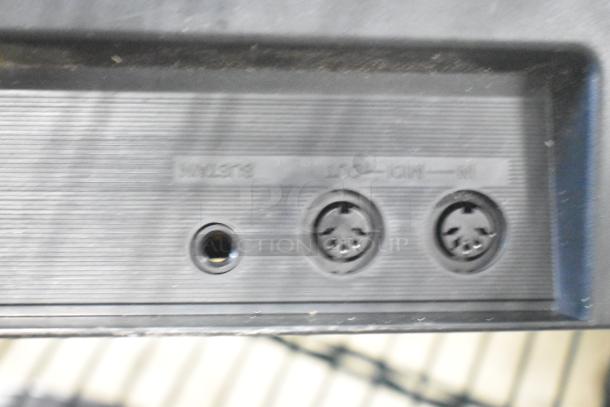 Close-up of Yamaha PSR-175 Keyboard ports, showing MIDI and power connections.
