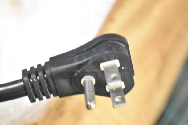 Close-up of a power plug from a Mr Induction SR-650M Single Burner Induction Range, 120 Volts, 1 Phase.