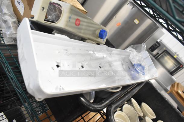 Mixed lot including white ceramic ramekins and black poly bus bins. Items appear used, in fair condition.