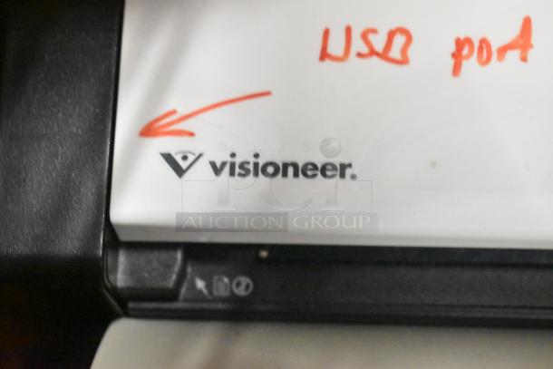 Visioneer logo on a white device, with handwritten "USB port" in red ink and an arrow pointing to the logo.
