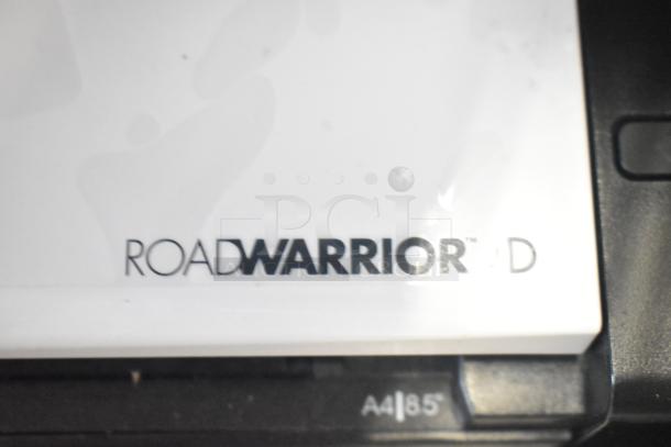 A close-up of a ROADWARRIOR device showing its brand label and part of the A4/85 marking.