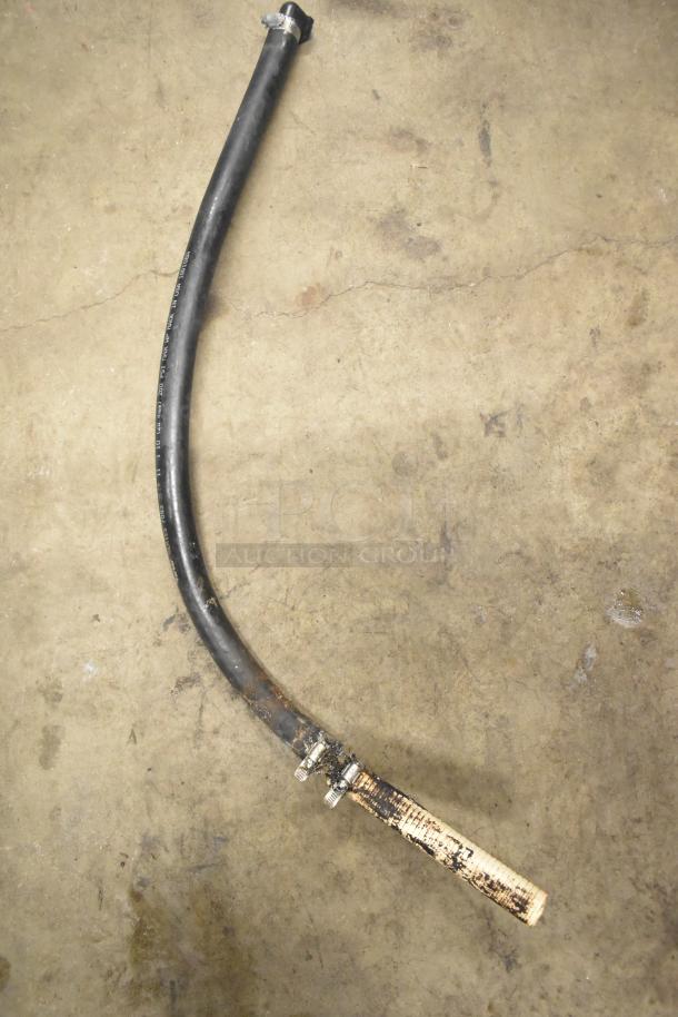 Assorted items lot including black rubber hose with metal clamps on concrete floor.