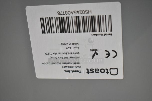Barcode and label of a Toast Inc. cash drawer, model T1200/T1200W, with CE and RoHS markings.