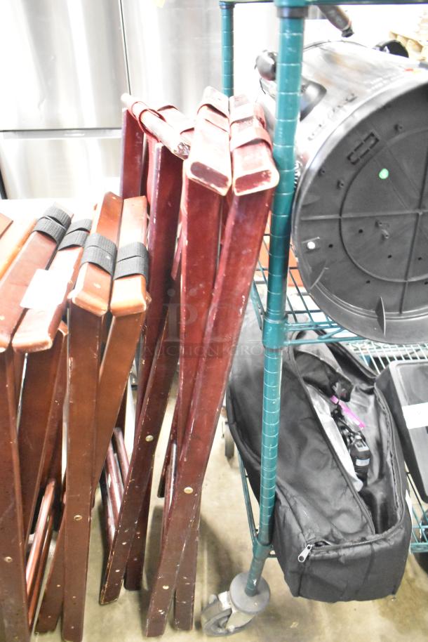 Five wooden serving tray stands in good condition, foldable with black straps, suitable for catering or events.