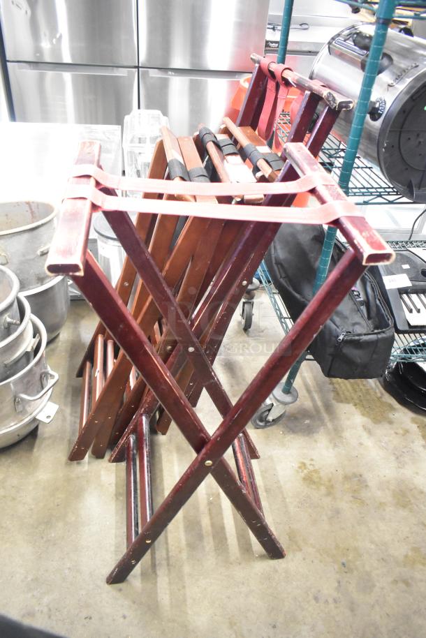 5 folding serving tray stands with sturdy wooden frames, in good condition, ideal for catering use.