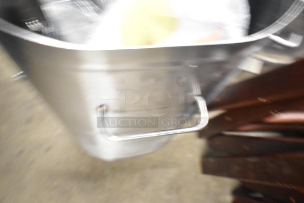 Blurry image of Bunn countertop beverage holder dispenser, metal construction, unclear features due to blur.