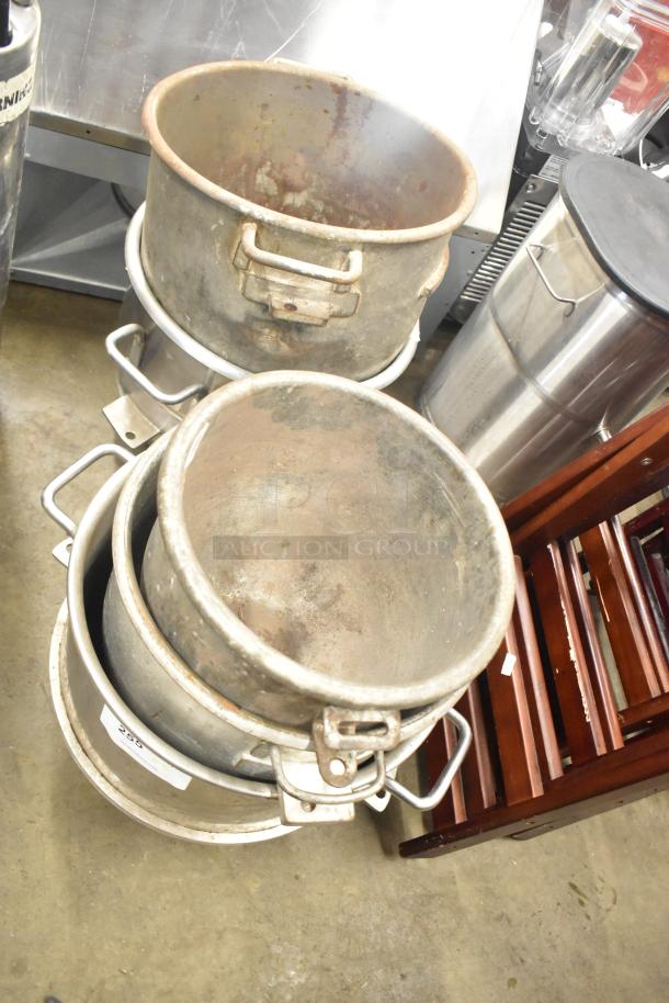 Five various metal mixing bowls stacked, showing signs of wear. Includes handles. Auction tag visible, reads "259."