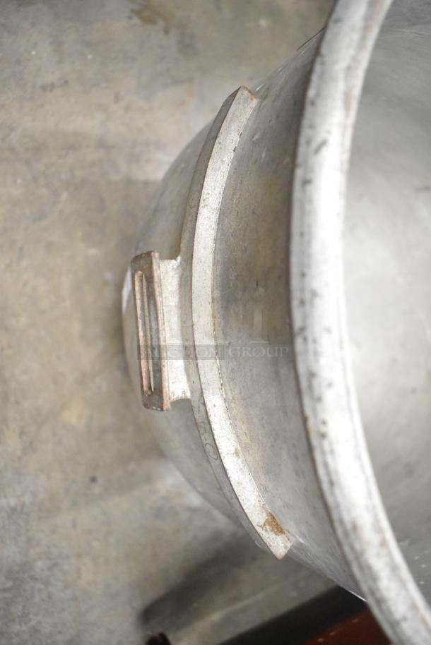 Five various metal mixing bowls, used, showing slight wear and patina. Sturdy build with a simple, functional design.