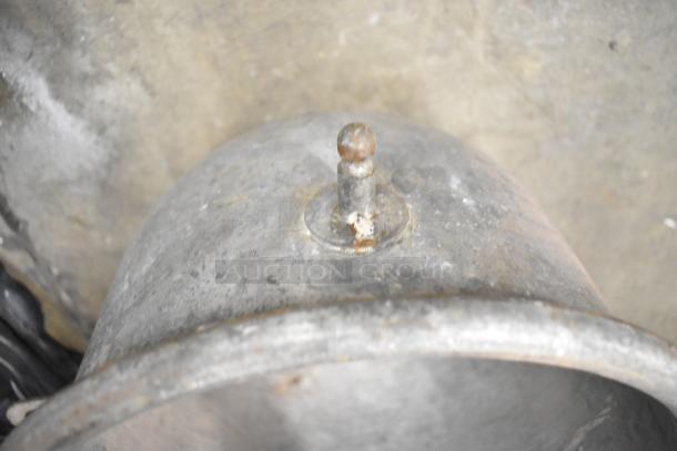 Set of five vintage metal mixing bowls with visible wear, showcasing a rustic, well-used condition.