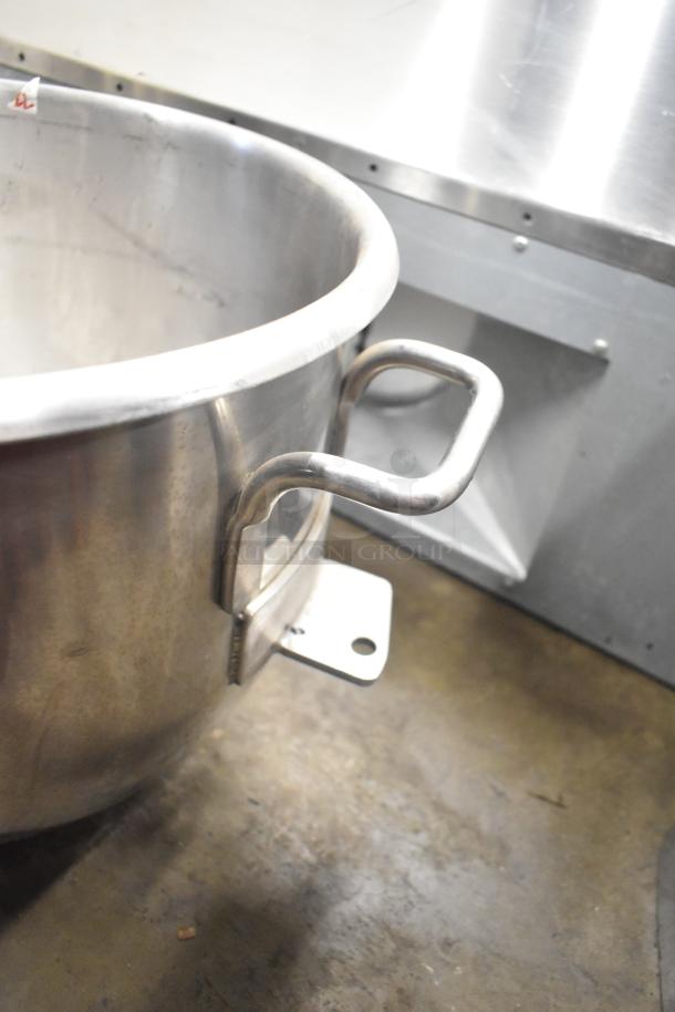 Five various metal mixing bowls with sturdy handles, in good condition. Visible mounting bracket for secure placement.