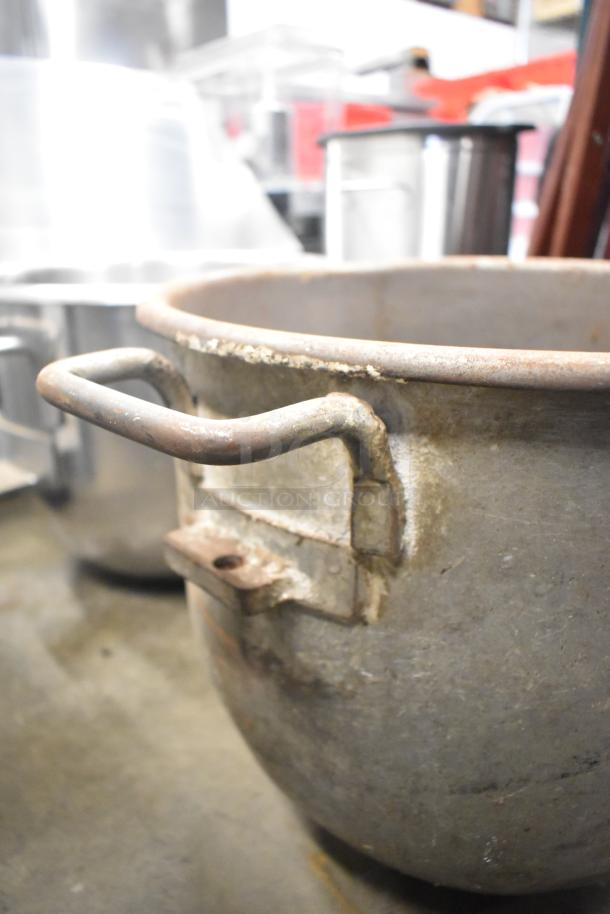 Rustic metal mixing bowl, vintage condition with visible wear, sturdy handles. Part of a set of 5 bowls.