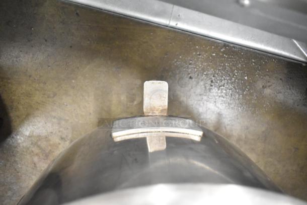 5 metal mixing bowls, varying sizes, industrial-grade finish, visible wear, labeled with capacity markings for kitchen use.