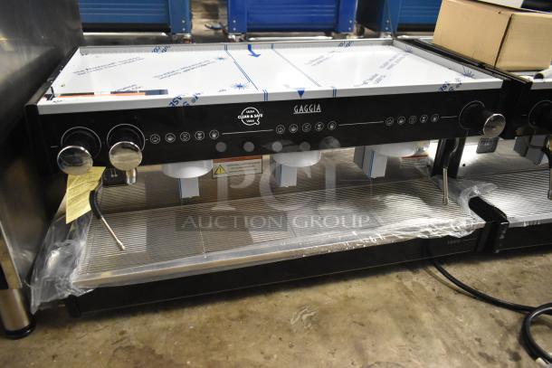 Brand new Gaggia MGV293NPU Vetro Black 3 Group Automatic Espresso Machine, label indicates 220/230 Volts, 1 Phase.