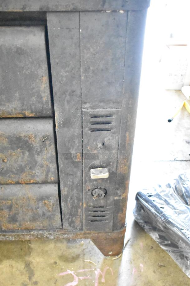 Blodgett commercial two-deck gas pizza oven, visible rust, and wear, sturdy construction, control knobs on the front panel.