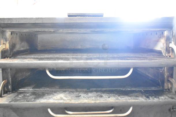 Blodgett commercial gas 2-deck pizza oven, metal construction, used condition, showing interior with racks and handles.