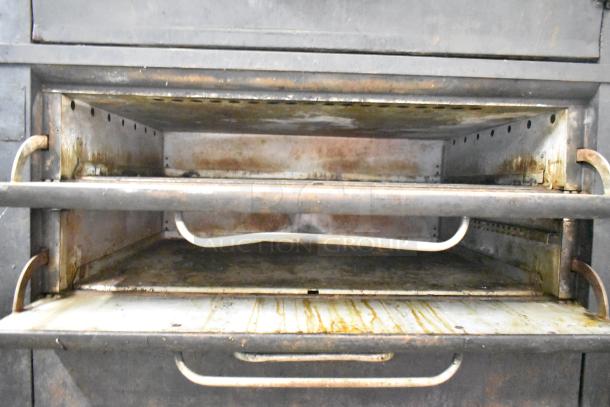 Blodgett commercial gas-powered double deck pizza oven, showing interior. Used condition with visible wear and residue.