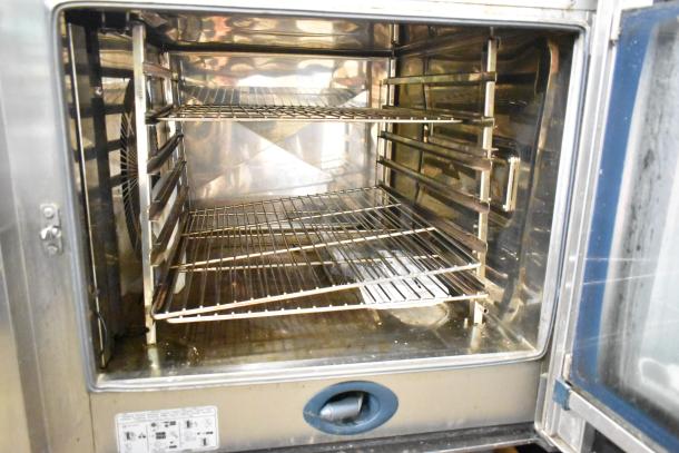 Rational CMP62G CombiMaster Plus convection oven, stainless steel interior, equipped stand, used, natural gas, 79,500/106,000 BTU.
