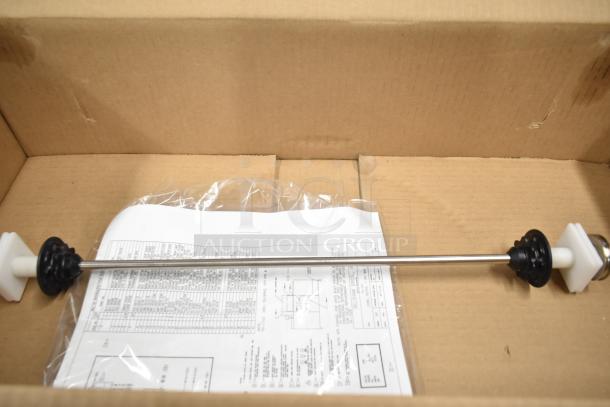 Box containing a part of the 2025 Belshaw Adamatic TG-50 Thermoglazing Station. Includes instructions and a wrapped metal rod with plastic ends.