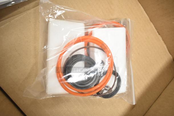 Sealed plastic bag containing orange and black rubber rings; accessories for Belshaw Adamatic TG-50 glazing station.