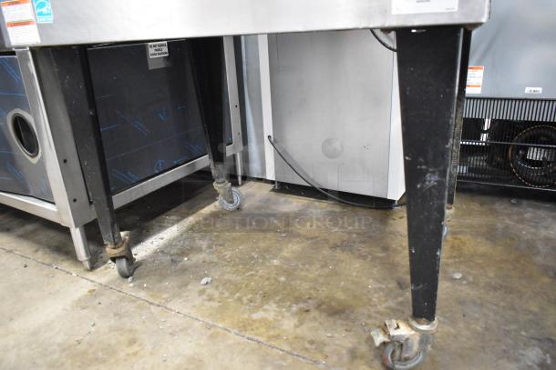 Vulcan commercial convection oven with view-through doors, thermostatic controls, and legs on commercial casters.