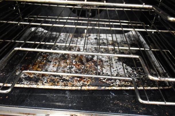 Vulcan full-size convection oven interior with racks, showing wear and use on surfaces. Model features thermostatic controls.
