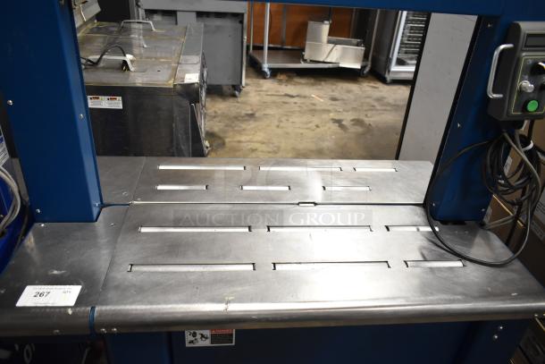 Polychem PC1000 automatic arch strapping machine on commercial casters, 115 volts, 1 phase, metal table surface, with control panel.