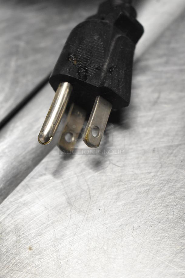 Close-up of a three-prong power plug for the Polychem PC1000 automatic arch strapping machine, indicating 115 volts, 1 phase.