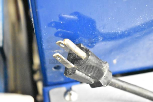 Polychem PC1000 strapping machine, commercial model on casters, 115 volts, 1 phase, close-up of plug and blue casing.