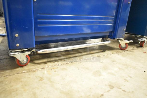 Polychem PC1000 strapping machine with commercial casters, 115V, 1-phase; blue finish, in excellent condition.