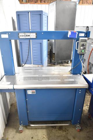 Polychem PC1000 automatic arch strapping machine, commercial floor style, on casters. Features 115 volts, 1 phase, excellent condition.