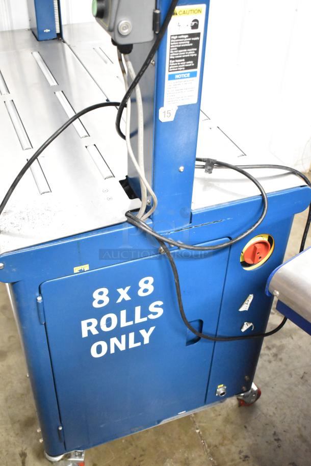 Polychem PC1000 automatic strapping machine, floor model on casters, 115V, 1 phase, "8 x 8 rolls only" label visible.