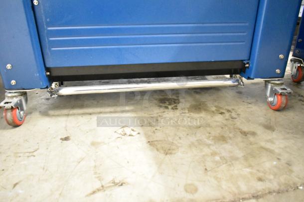 Polychem PC1000 automatic arch strapping machine, commercial floor style, on casters; 115V, 1 phase; blue housing.