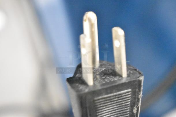 Polychem PC1000 automatic arch strapping machine plug, close-up view showing three-prong design.