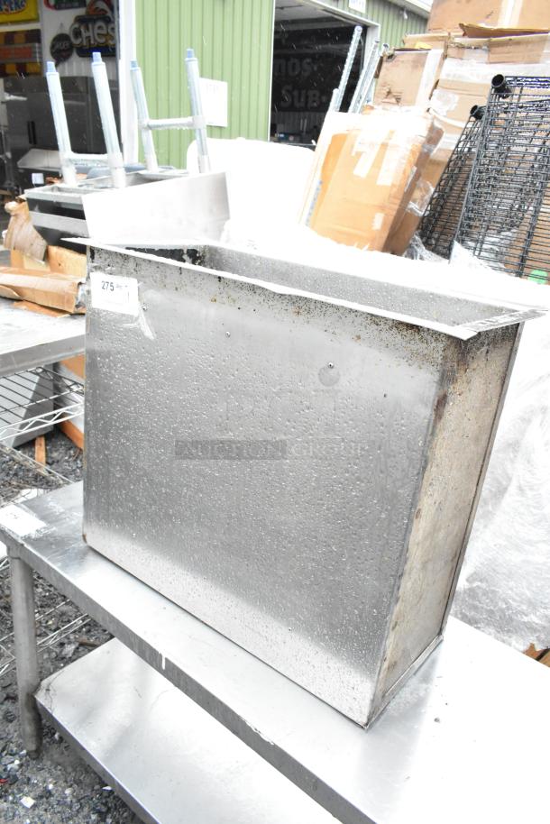 Metal bin with visible wear, stainless steel material, slightly tarnished surface, numbered tag "275" attached.
