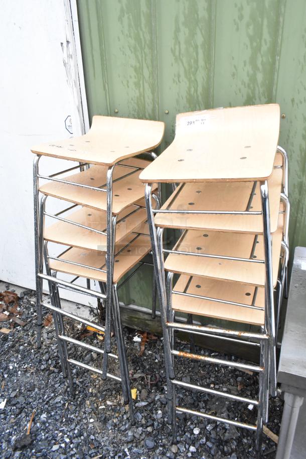 8 bar height stools with wood-pattern seats and chrome legs, stacked. Good condition. Bid covers all 8.