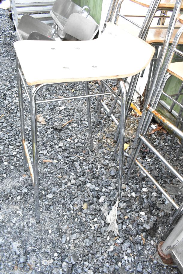 Set of 8 bar height stools with wood pattern seats and chrome legs; outdoor condition, slight rust on some legs.
