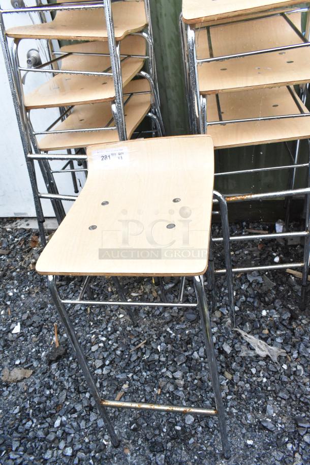 8 bar height stools with wood pattern seats and chrome legs. Visible tag reads "281" and "Qty x 8." Signs of light wear.