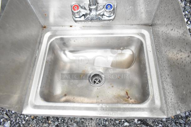 Krowne WM260 wall mount sink with faucet, hot/cold handles, side splash guards; visible wear and water stains.