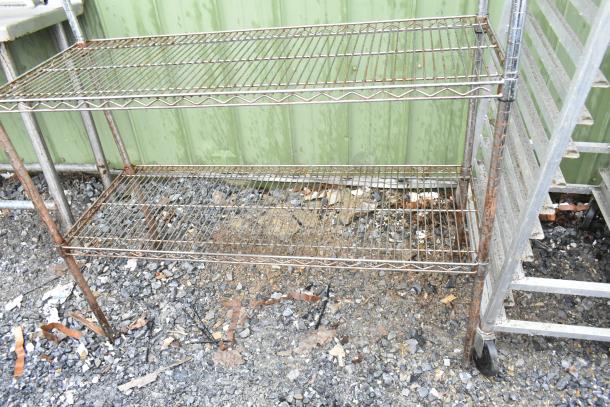 Chrome finish 4-tier wire shelving unit, outdoor setup, visible wear, buyer must dismantle for shipping.