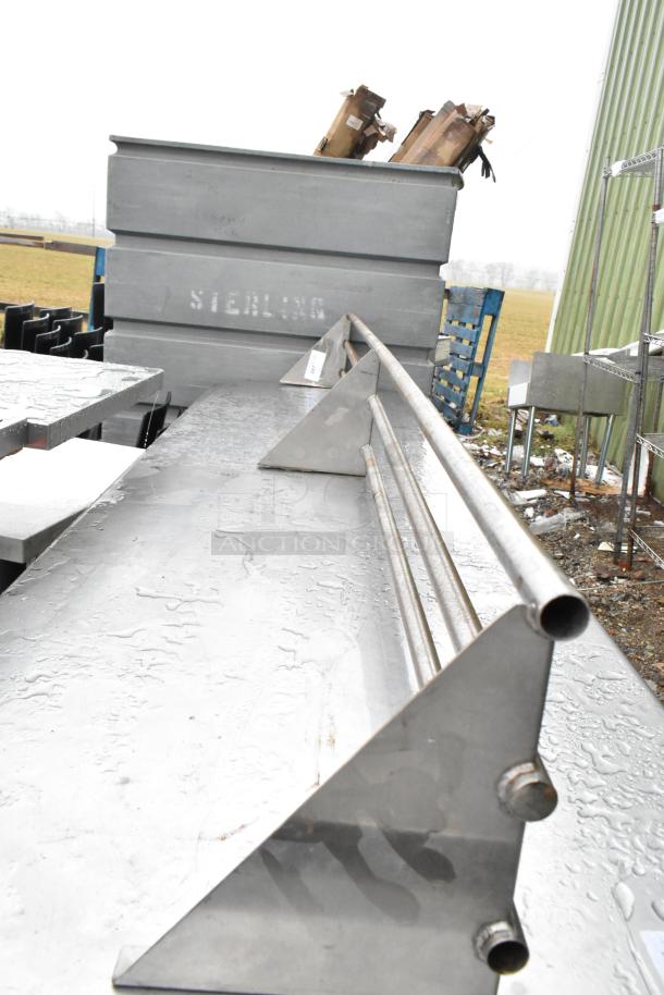 Metal tray slide in good condition, features raised rails, sturdy construction, slightly wet surface, marked "Sterling."